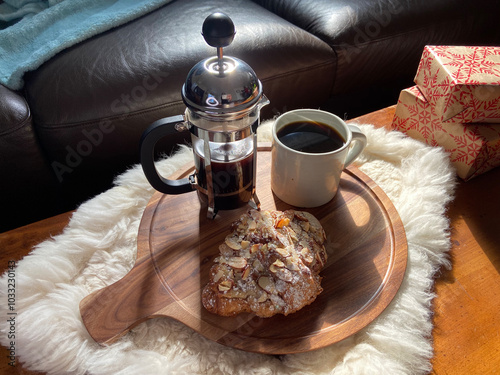 Wintertime still life with French-press coffee, croissant and gifts