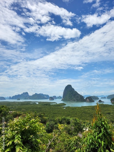 Aerial Landscape Vertical View of Samet Nangshe Viewpoint in Phang Nga, Thailand with Lush Green Mangrove Forest and Dramatic Limestone Islands on a Clear Day with Blue Skies 