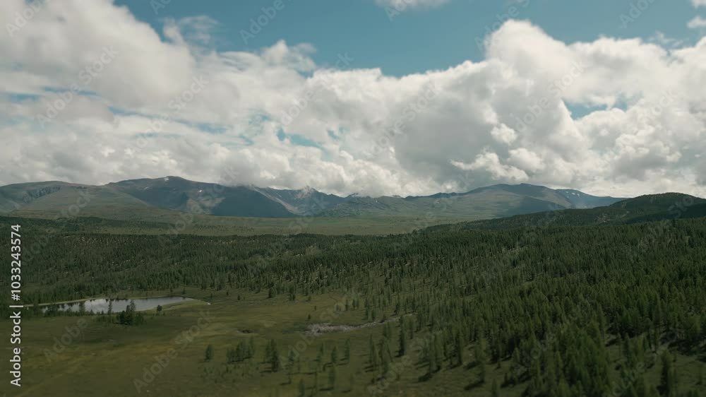 Drone flying over a mountain lake. Landscape of a mountain lake against the backdrop of mountains. Reflection of clouds in the lake. Drone flying over a mountain lake. Landscape of a mountain lake against the backdrop of mountains. Reflection of clouds in the lake.