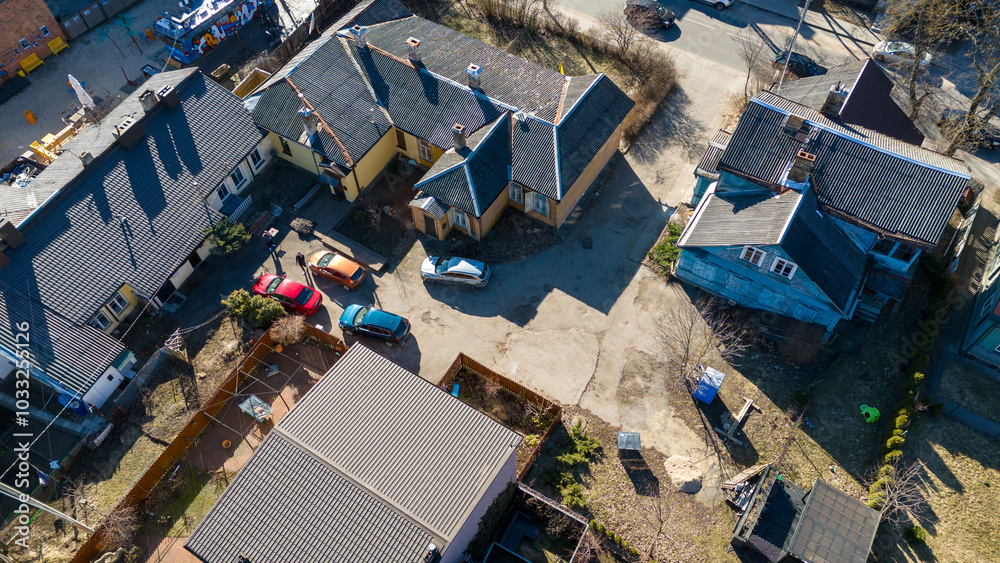 Aerial view of a residential area with several houses and parked cars Aerial view of a residential area with several houses and parked cars