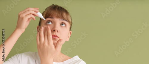 Young woman using eye drops...
