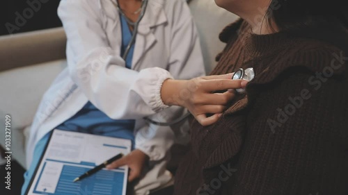 Doctor use stethoscope, checking up heart beat, lunch of auscultation in doctor office at hospital. Patient worker has to get medical checkup every year for her health or medical checkup cardiologist