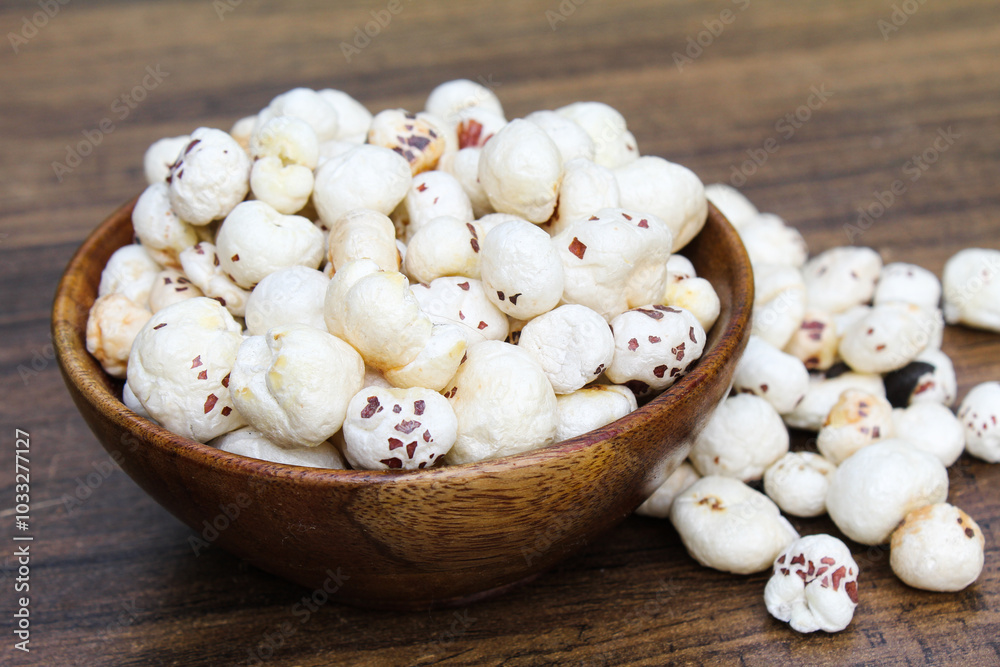 Fox nuts or makhaana in a wooden bowl side view Fox nuts or makhaana in a wooden bowl side view