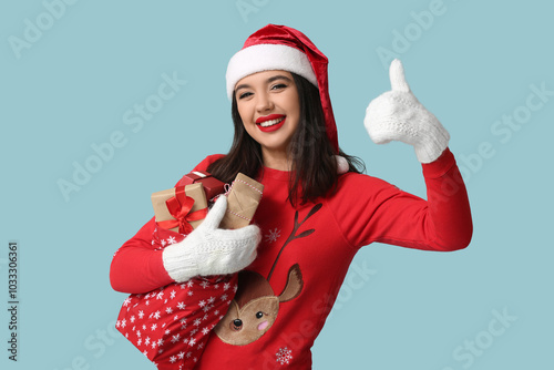 Happy young woman in santa ...