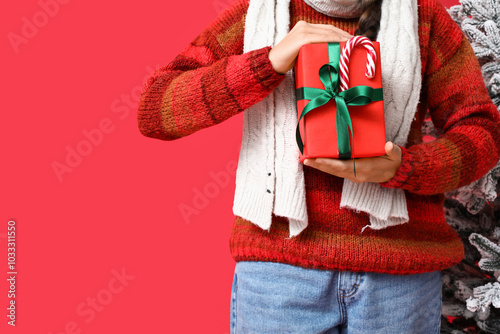 Person in festive sweater h...