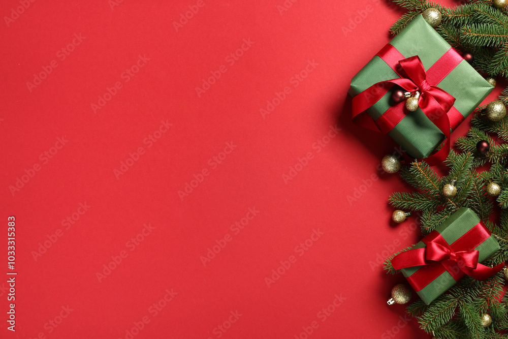 Gift boxes with Christmas tree branches and balls on red background Gift boxes with Christmas tree branches and balls on red background