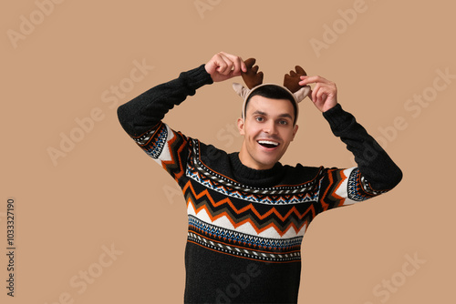 Happy young man in reindeer...