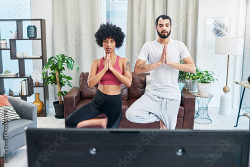 Meditation, television and yoga with couple in living room of home for balance or holistic exercise. Fitness, streaming or watching tv with man and woman in apartment for pilates or wellness photo