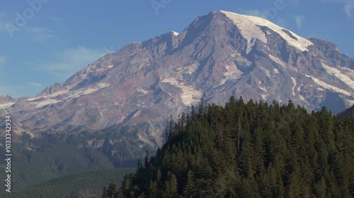 Closeup Aerial View of Mount Rainier's Snow-Capped Peak and Forested Slopes in Washington State