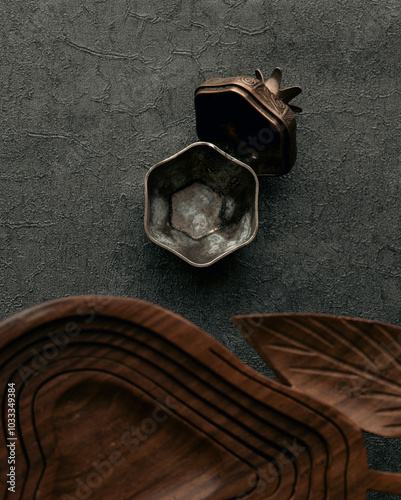 Top down view of wooden utensils and small bronze traditional turksih delight bowl on grey textured background photo