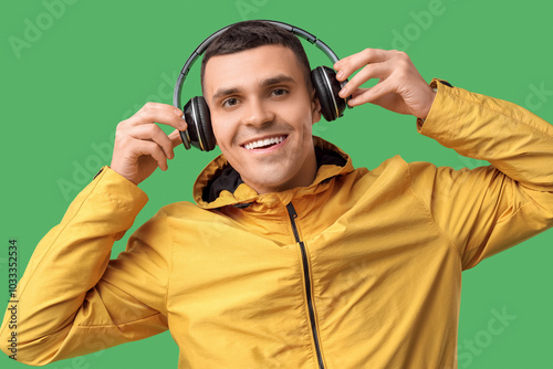 Smiling young man in yellow...