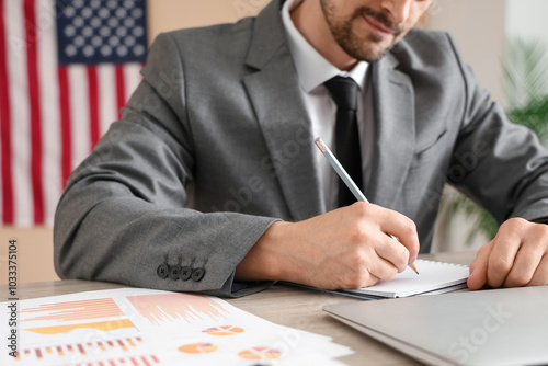 Businessman writing notes w...