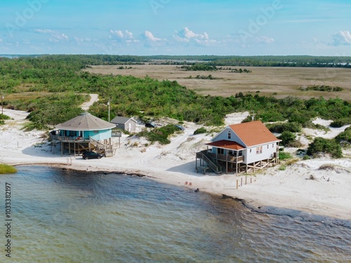 Holiday homes on stilts on sandunes at the waters edge on Cedar Island, North Carolina, United States. photo