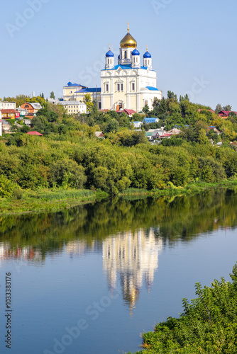 A beautiful blue and white church is reflected in the water