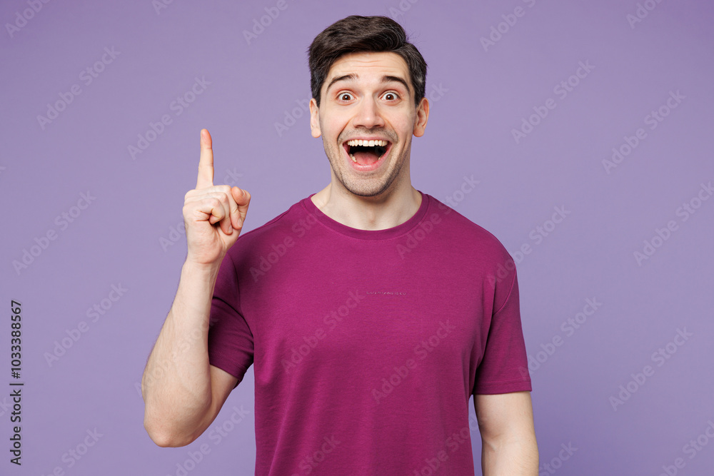 Young insighted smart proactive man wear violet t-shirt casual clothes holding index finger up with great new idea isolated on plain pastel light purple background studio portrait. Lifestyle concept. Young insighted smart proactive man wear violet t-shirt casual clothes holding index finger up with great new idea isolated on plain pastel light purple background studio portrait. Lifestyle concept.