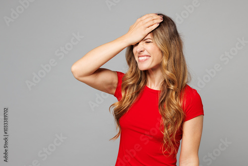 Young sad unhappy woman she wear red t-shirt casual clothes put hand on face facepalm epic fail mistaken omg gesture isolated on plain pastel light grey background studio portrait. Lifestyle concept.