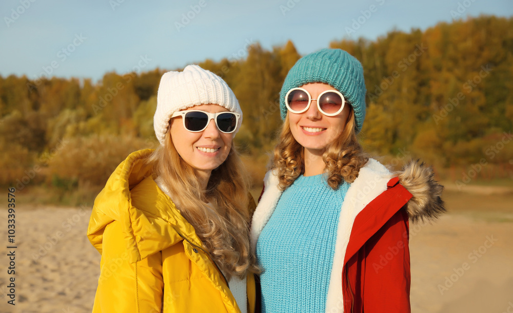 Happy young two women friends on sunny beach, stylish girlfriends smiles together on sea coast Happy young two women friends on sunny beach, stylish girlfriends smiles together on sea coast