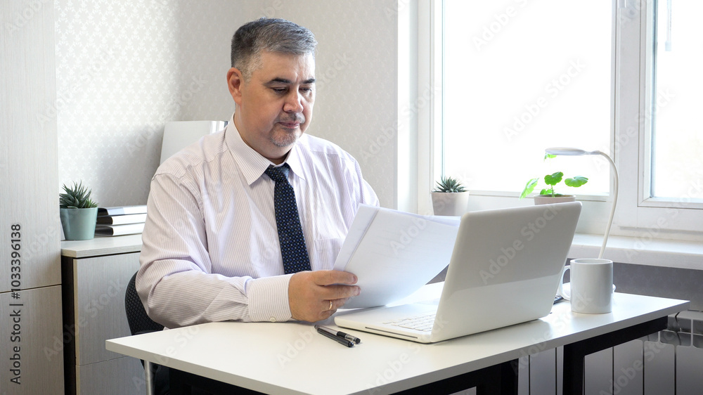 Man Working with Documents at Office Desk Man Working with Documents at Office Desk