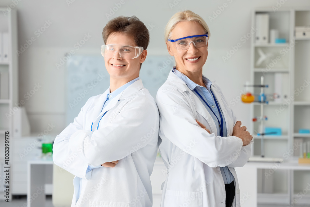 Chemists with safety goggles in laboratory Chemists with safety goggles in laboratory