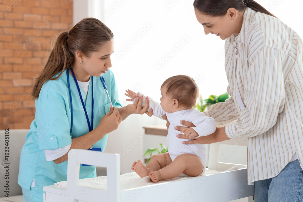 Female pediatrician with little baby on changing table and mother at home Female pediatrician with little baby on changing table and mother at home