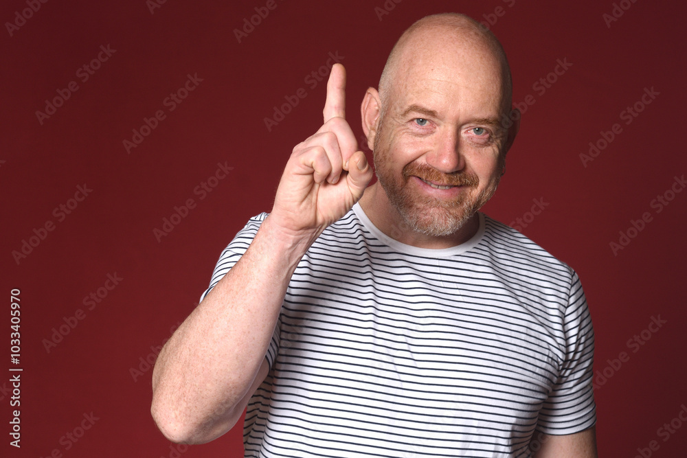man with a raised finger on red background man with a raised finger on red background
