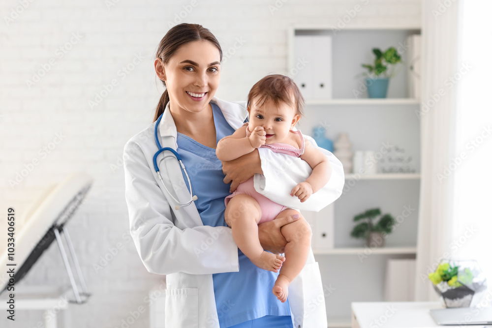 Female pediatrician holding little baby in clinic Female pediatrician holding little baby in clinic