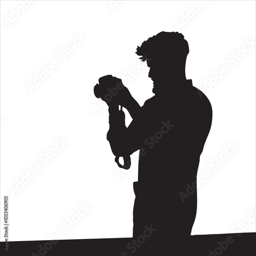 Silhouette of a male photographer examining his camera against a stark white background.