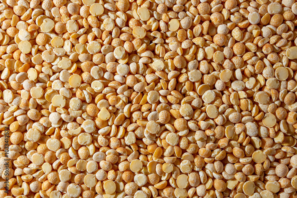 Uncooked Polished Split Peas Background. A Culinary Canvas of Dry Yellow Peas, Creating a Lively and Textured Background for Gourmet Cooking. Scattered Raw Polished Peas. Healthy Eating Ingredients Uncooked Polished Split Peas Background. A Culinary Canvas of Dry Yellow Peas, Creating a Lively and Textured Background for Gourmet Cooking. Scattered Raw Polished Peas. Healthy Eating Ingredients