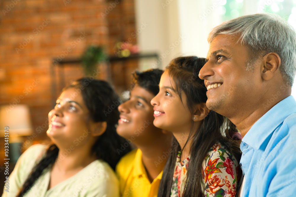 Obraz premium Cheerful Indian Asian family poses for a close-up photo while sitting on the sofa