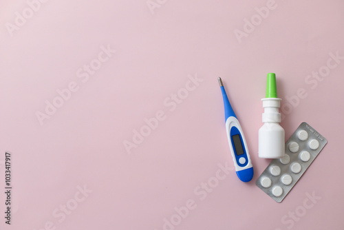 Seasonal diseases. Cold, runny nose, cough Medicines, spray and syrup, thermometer, pills, capsules on pastel background