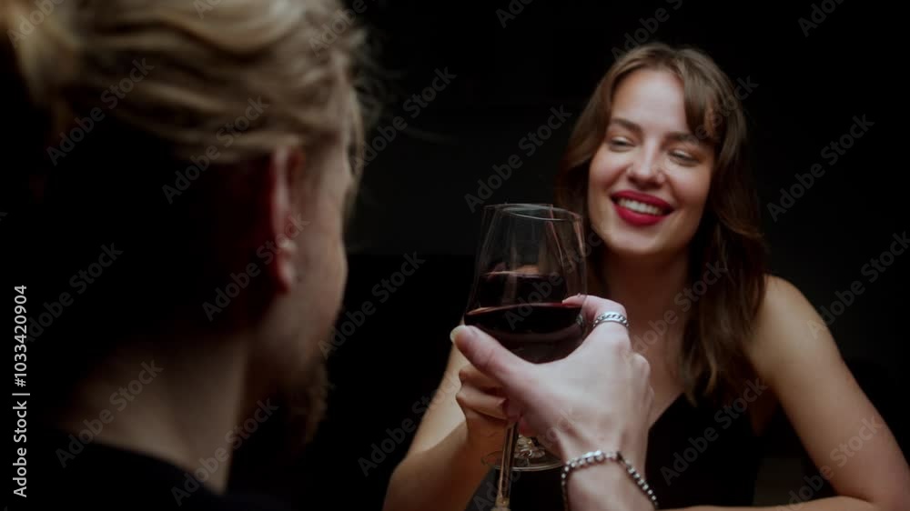 A Woman is Smiling at a Man as She Drinks Red Wine - Close Up A Woman is Smiling at a Man as She Drinks Red Wine - Close Up