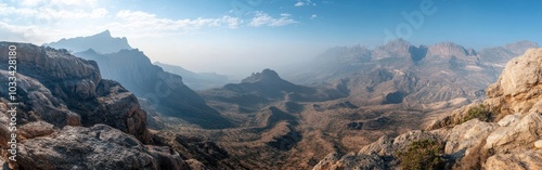 A Panoramic View of Mountainous Terrain with a Hazy Sky