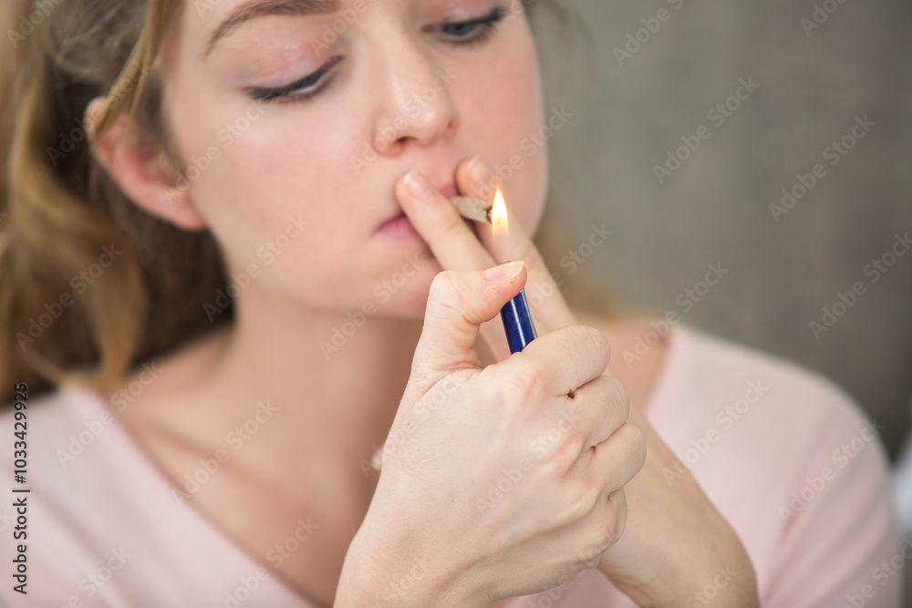 close up of woman lighting marijuana joint at home close up of woman lighting marijuana joint at home