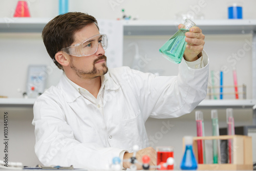 handsome student of chemistry working with chemicals