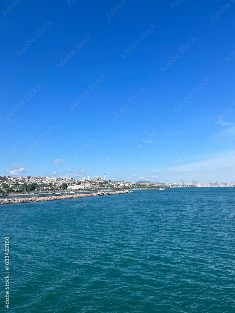 Serene Mediterranean seascape with a distant coastline and clear blue sky Serene Mediterranean seascape with a distant coastline and clear blue sky