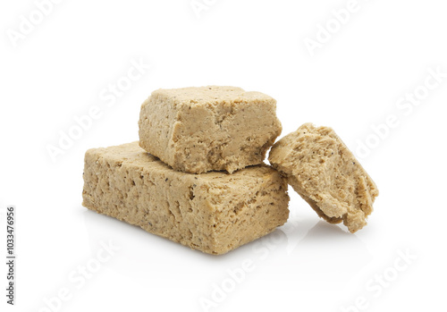 Pieces of halva from sunflower seeds, isolated on white background  