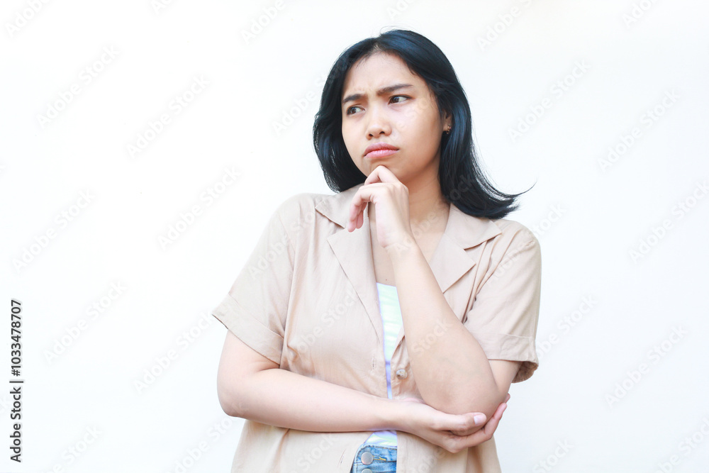 thoughtful asian woman thinking seriously wearing casual brown clothes isolated on white background thoughtful asian woman thinking seriously wearing casual brown clothes isolated on white background