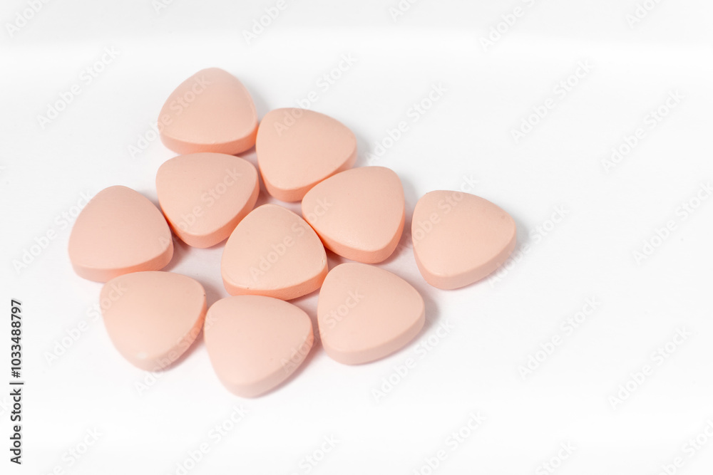 Close-up of pink pills on a clean white background, creating a minimalistic and medical-themed composition, ideal for health and pharmaceutical content.