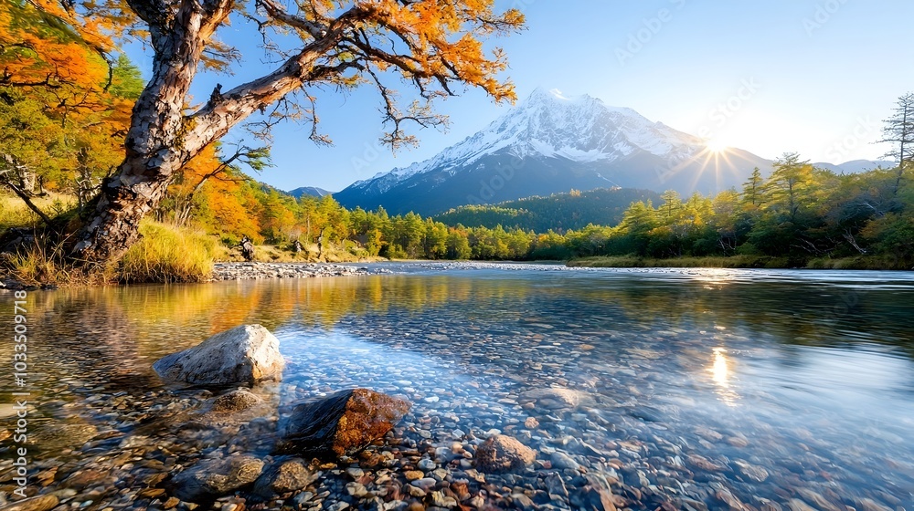 Breathtaking landscape with the sun rising behind a towering snow capped mountain peak casting its warm glow over the crystal clear river below creating a serene and natural scene Breathtaking landscape with the sun rising behind a towering snow capped mountain peak casting its warm glow over the crystal clear river below creating a serene and natural scene