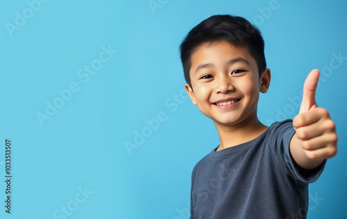 Excited young boy giving thumbs up