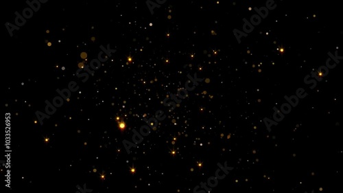 Abstract background with glittering gold dust particles on a black background.