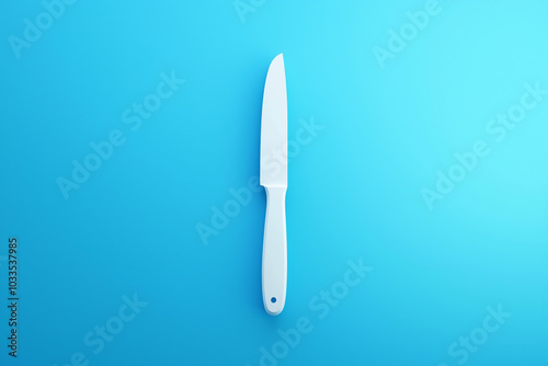 White knife centered on vibrant blue minimalistic background composition