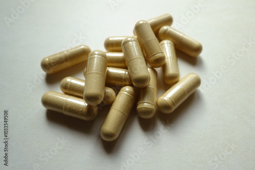 Heap of beige capsules of Saccharomyces boulardii probiotic dietary supplement photo