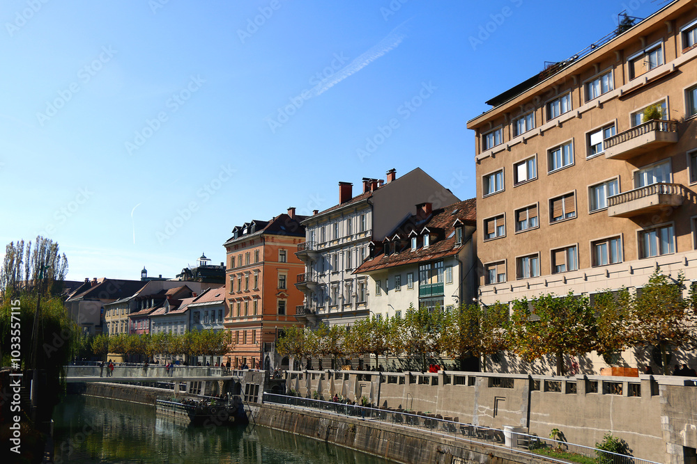Picturesque historical buildings in central Ljubljana, capital of Slovenia. Autumnal foliage on the trees. Picturesque historical buildings in central Ljubljana, capital of Slovenia. Autumnal foliage on the trees.