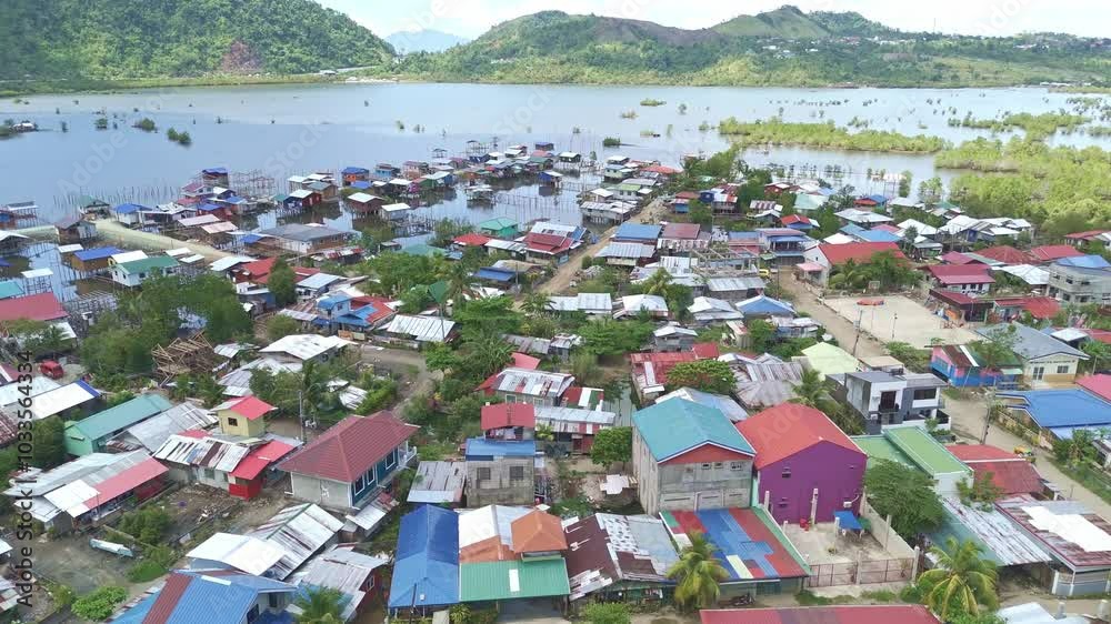 Aerial view of squatted housing in Surigao City, showing close-packed rooftops and narrow pathways within the settlement Aerial view of squatted housing in Surigao City, showing close-packed rooftops and narrow pathways within the settlement
