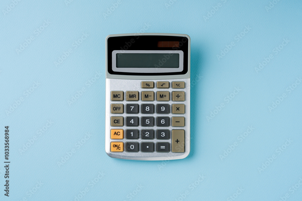 Top view of electronic calculator on blue background Top view of electronic calculator on blue background