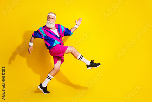 Full length photo of attractive funny retired sportsman retro sportswear enjyoing jogging emtpy space isolated yellow color background