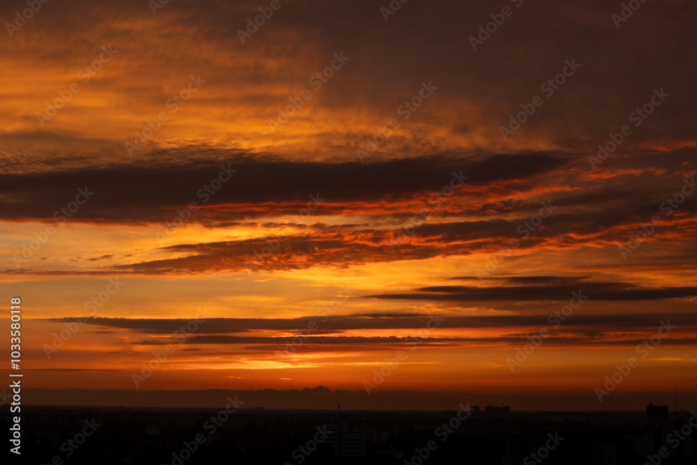 Dramatic panorama of colourful cloud formations in a vast sky - orange sunset Dramatic panorama of colourful cloud formations in a vast sky - orange sunset