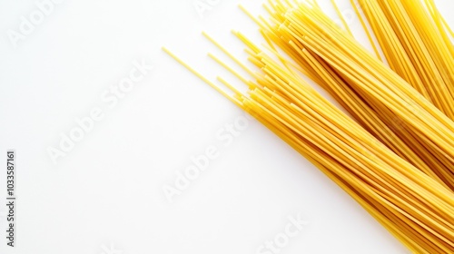 A close-up of uncooked spaghetti noodles on a white background, ready for cooking.