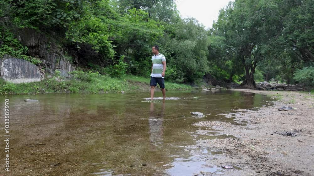 Isolated Man Walking in Natural River Stream During Morning Isolated Man Walking in Natural River Stream During Morning
